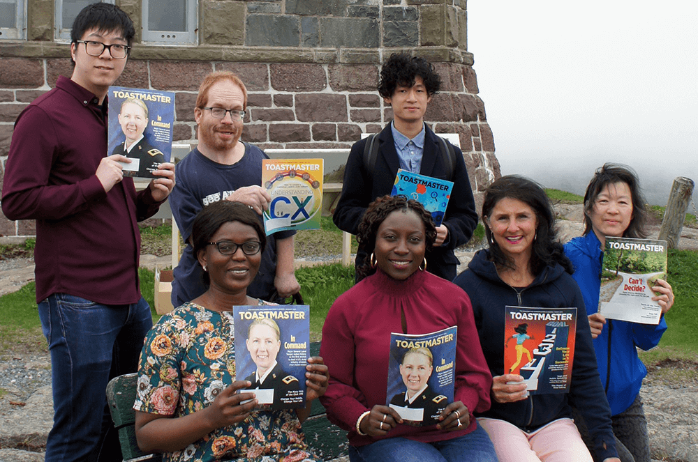 People holding magazines outside