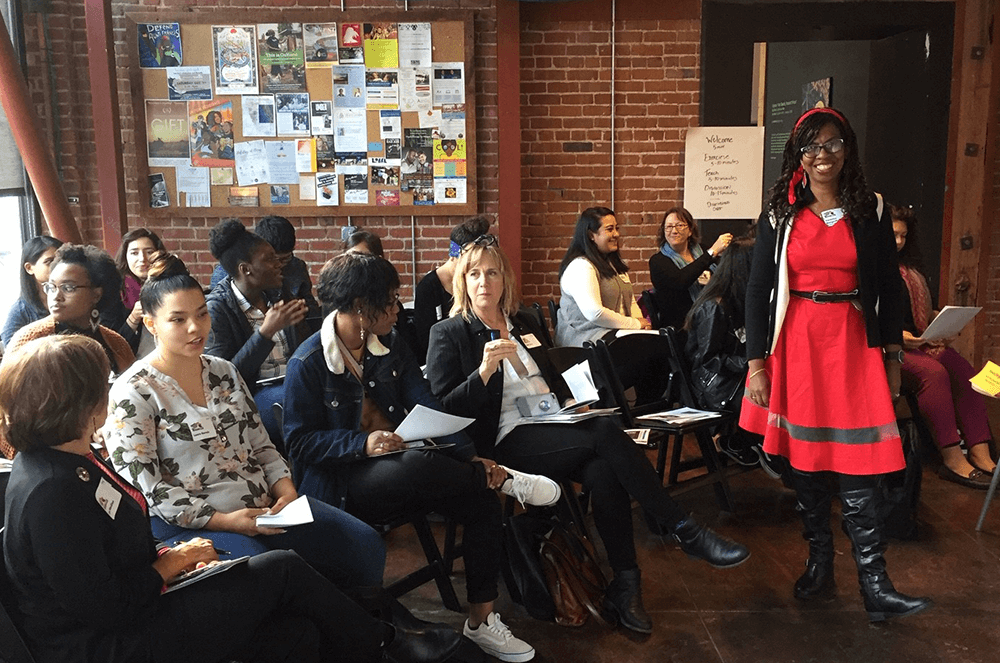 Woman in red dress teaching group