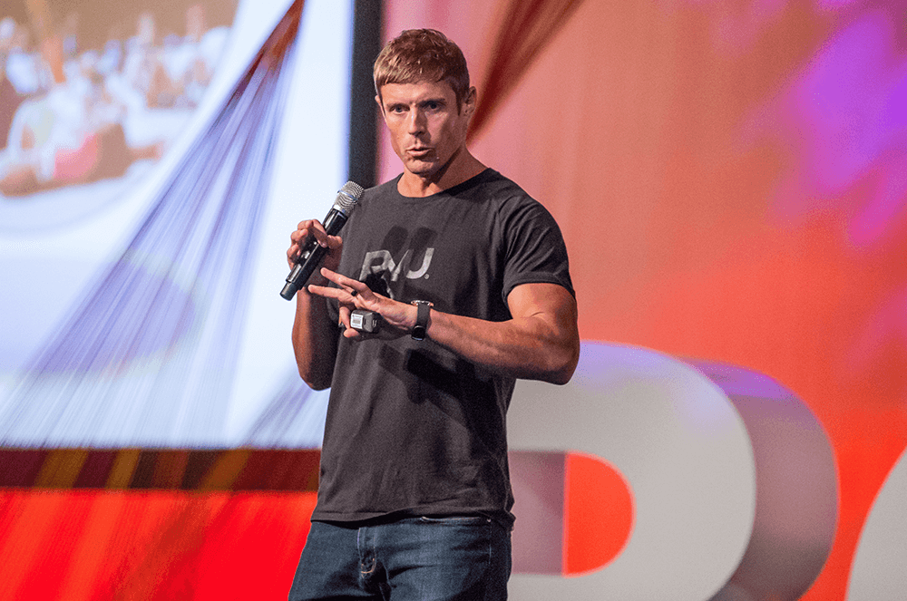 Man speaking into microphone onstage