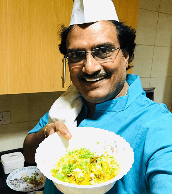 Man in hat holding up rice dish