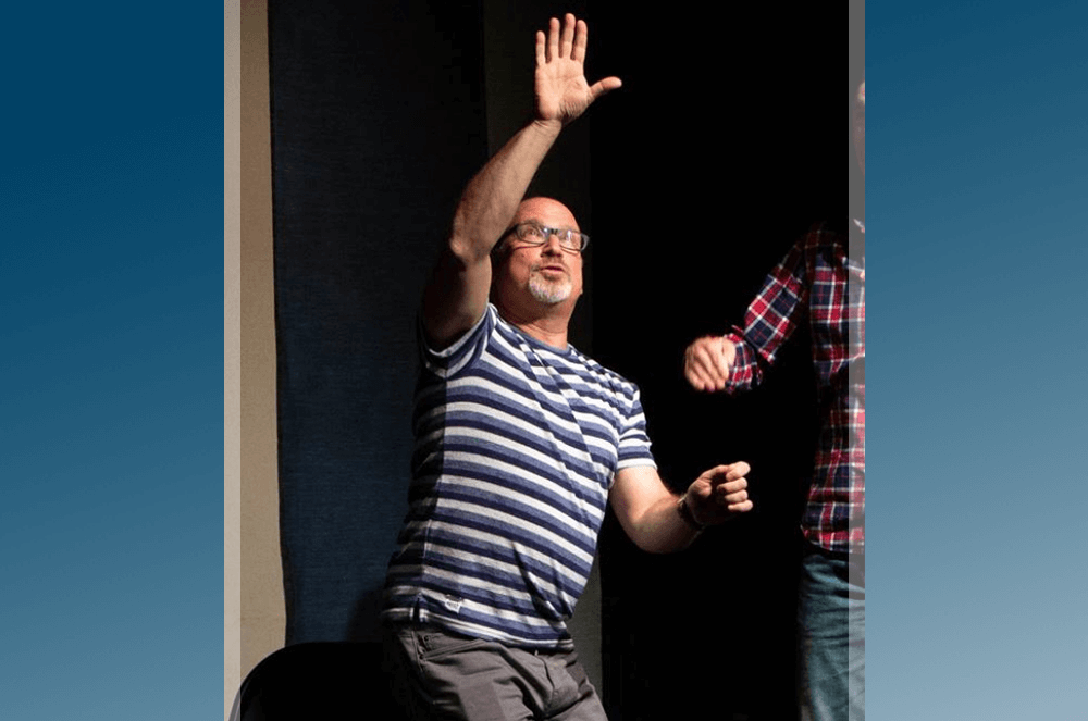 Man doing improv onstage