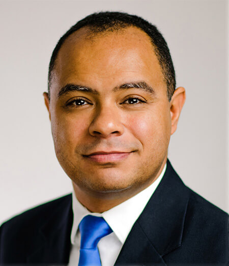 Man in black jacket and blue tie